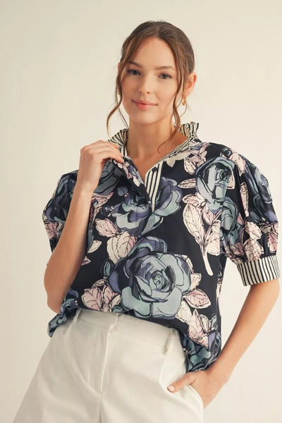 Woman wearing a floral blouse with a neutral background