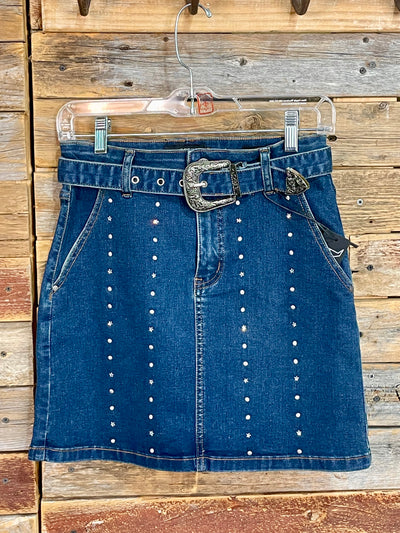 Blue denim skirt with decorative buttons and a belt on a wooden background