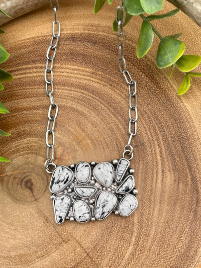 black & white cluster necklace on wooden background
