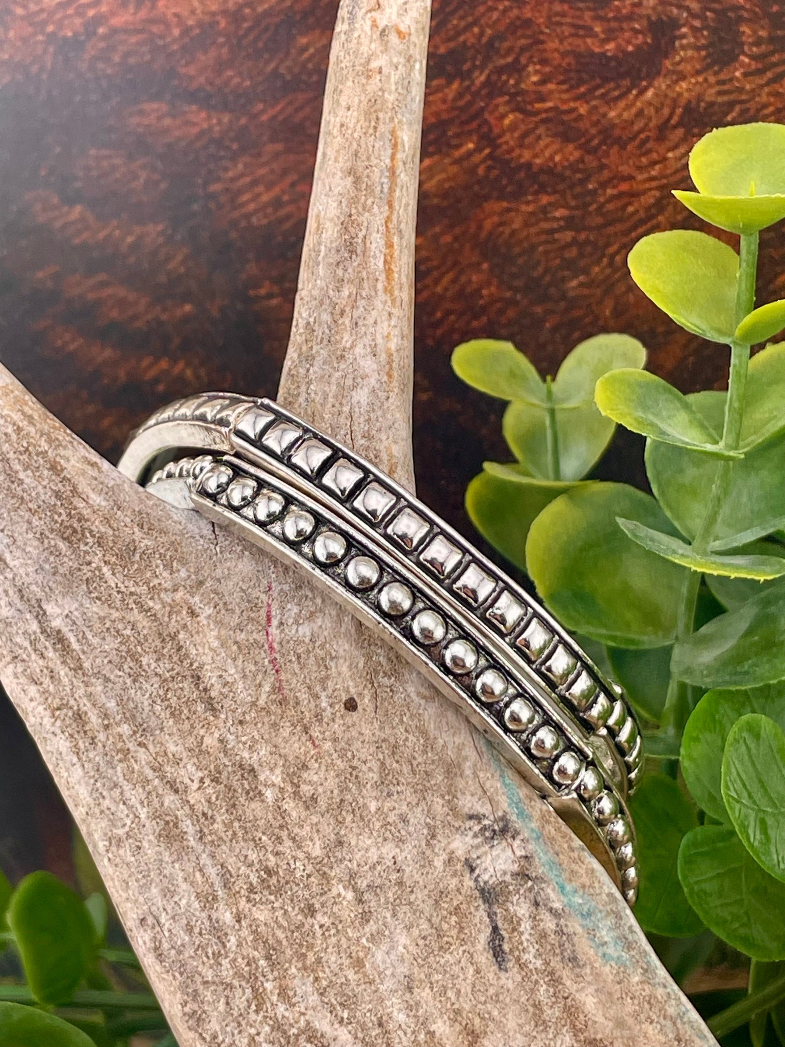 two silver bracelets on display