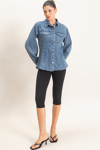 model wearing button down denim jacket and black pants with a light background