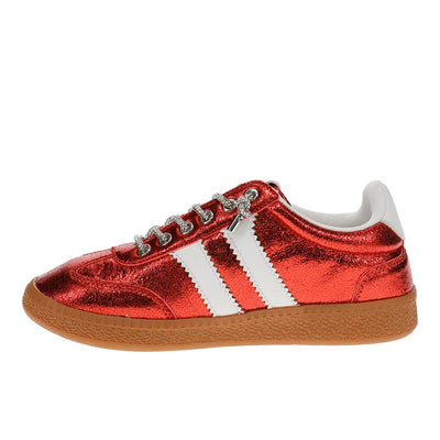 A metallic red low-top sneaker with three white stripes, silver rhinestone laces, and a brown gum sole, shown in profile against a white background.