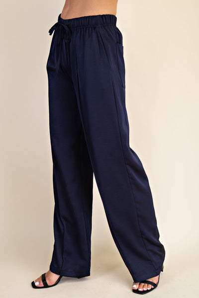 Navy blue wide-leg pants on a beige background