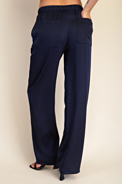 Navy blue wide-leg pants on a beige background