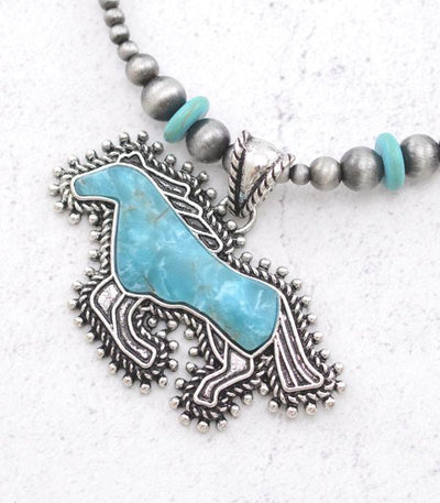 close up of turquoise horse Pendant on white background