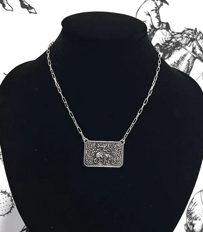 tooled bronc rider silver bar necklace  on a black bust