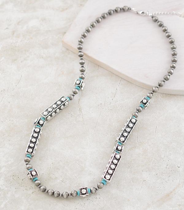 Necklace with gray beads and silver accents on a light background