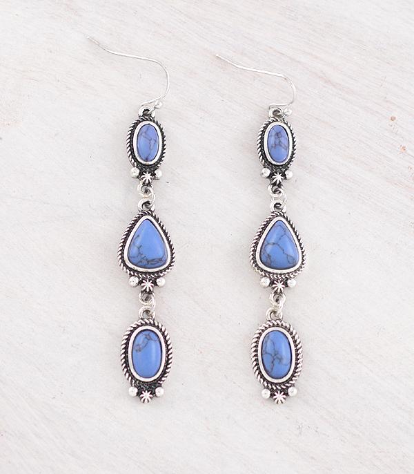 triple stone blue earrings on a gray surface