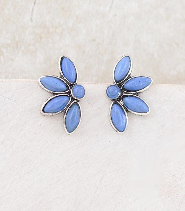 Pair of blue flower-shaped earrings on a light background