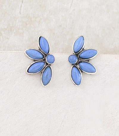 Pair of blue flower-shaped earrings on a light background