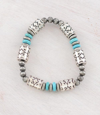 Bracelet with silver beads and turquoise accents on a light background