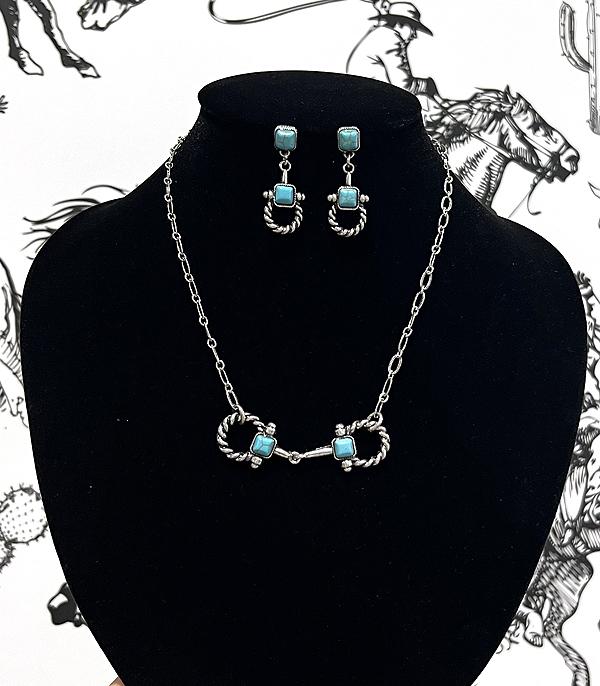 silver bit necklace and earrings on display