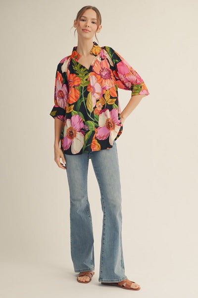 model wearing a floral top & jeans