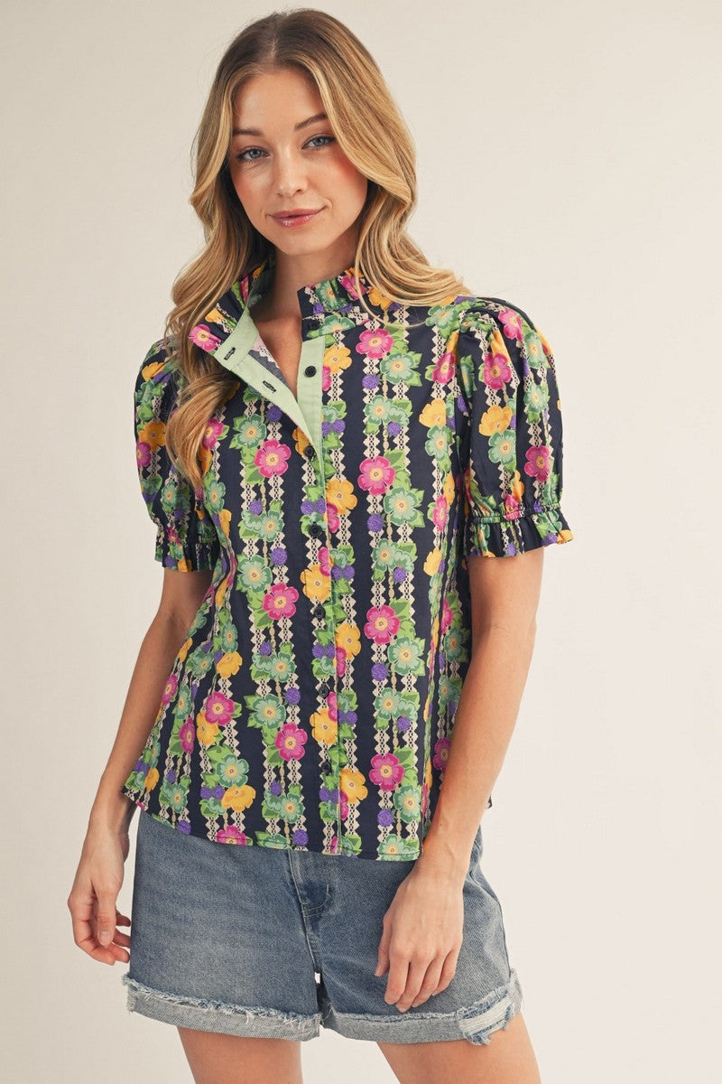 model wearing button down floral top & cuffed denim shorts