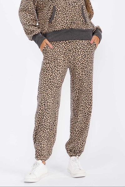 Woman wearing a leopard print outfit on a white background