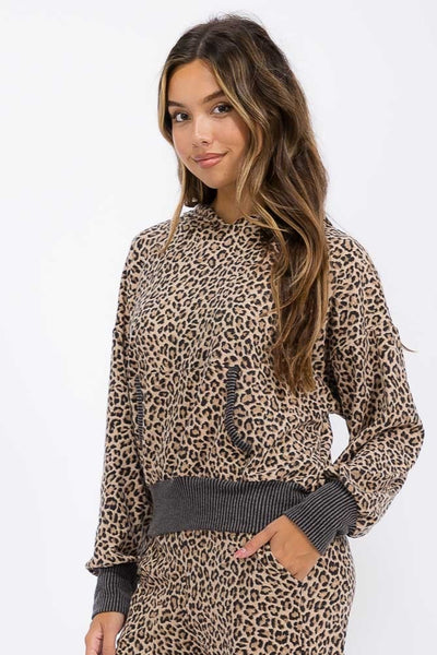 Woman wearing a leopard print outfit with a white background