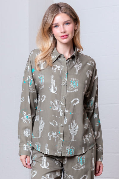 Woman wearing a patterned shirt and pants against a white background