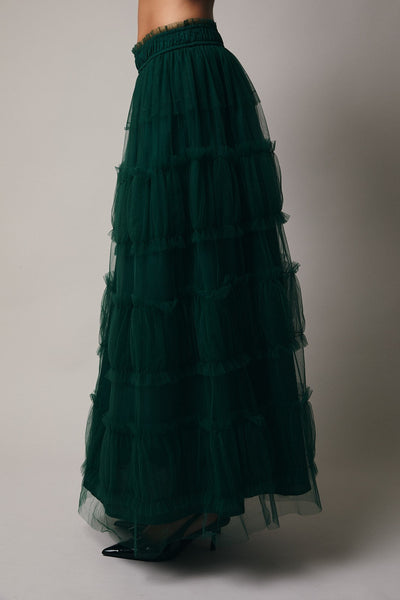 Green tiered skirt on a plain background