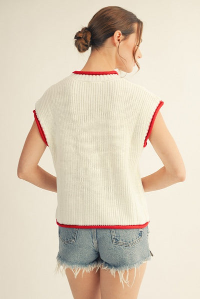 back model wearing an American flag sweater with cutoff denim shorts