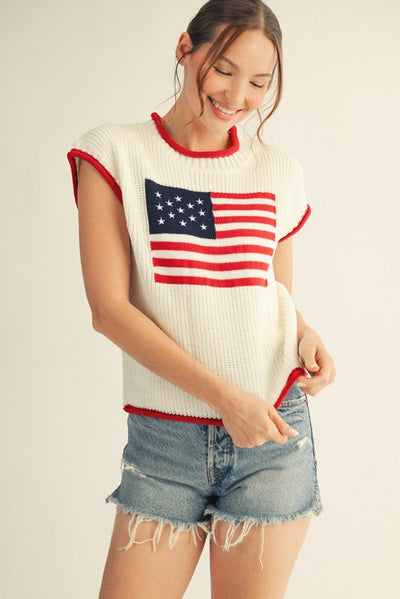 model wearing an American flag sweater with cutoff denim shorts