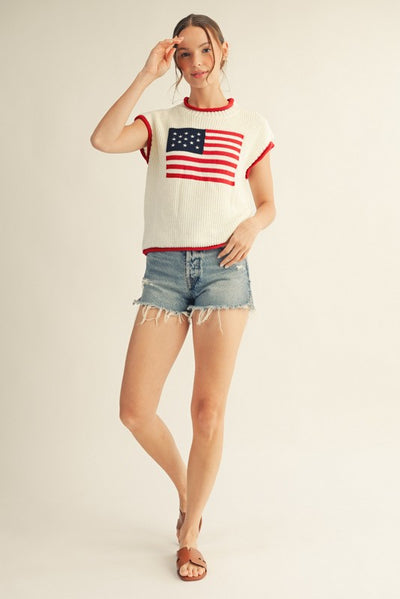 model wearing an American flag sweater with cutoff denim shorts