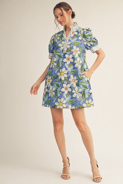 model wearing a a blue floral shift dress