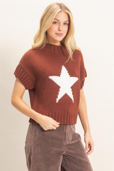 model wearing a short sleeve star sweater with charcoal pants