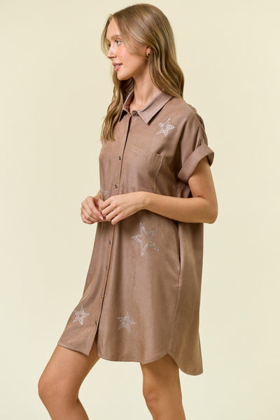 Woman wearing a brown dress with star patterns on a beige background