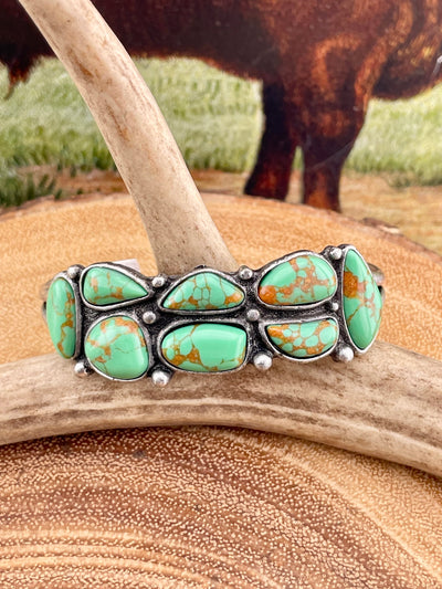 green turquoise cuff on wooden background