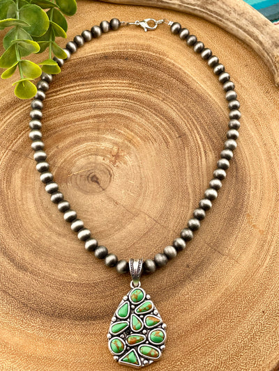 fashion silver bead necklace with cluster pendant on wooden background