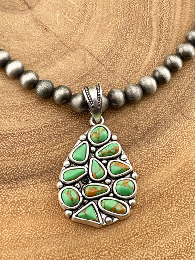 close up of cluster pendant on wooden background