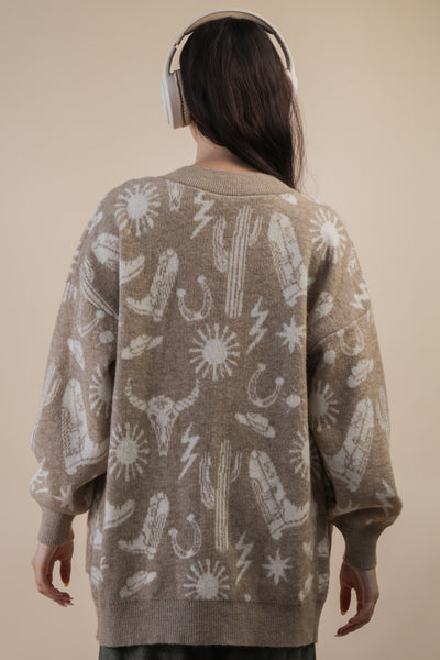 Person wearing a brown sweater with white abstract patterns on a beige background