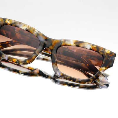Tortoiseshell sunglasses with brown lenses on a white background