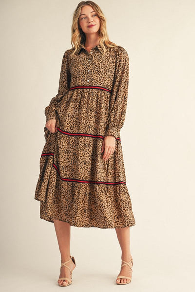 model wearing long sleeve leopard print dress with black/red contrast detail with a beige background