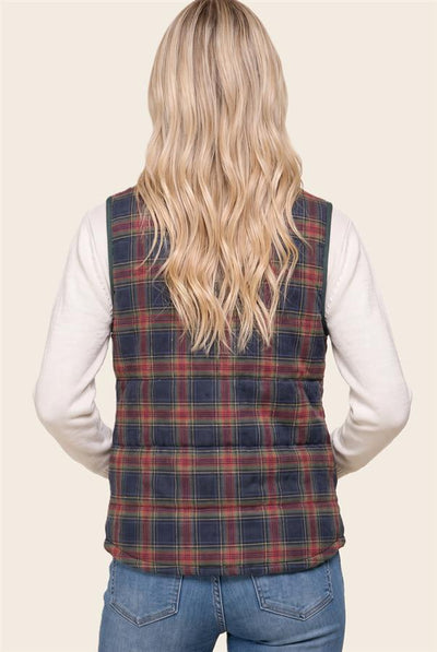 back view of woman wearing a cream top and jeans with a navy/red/taupe plaid vest.