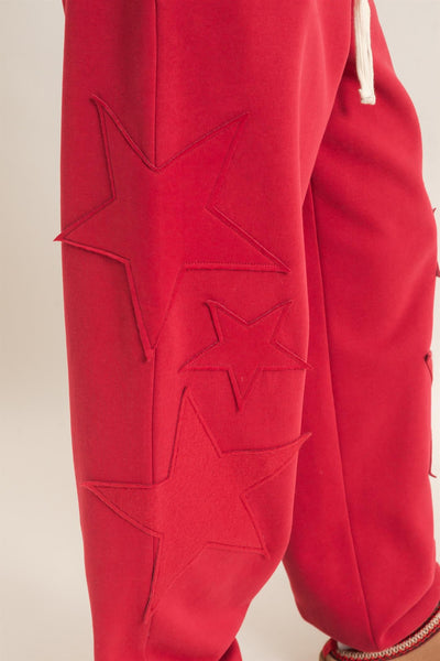 close up of start patch on red joggers