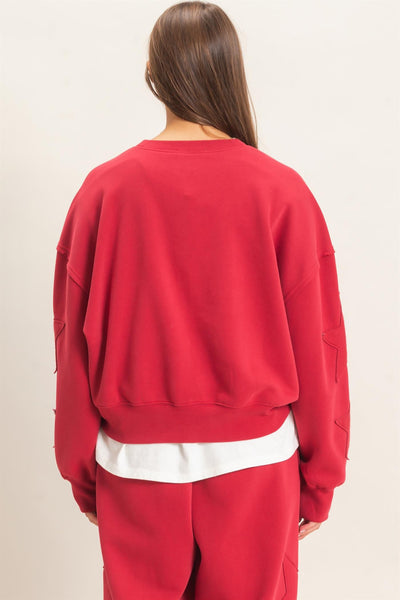 back of model wearing start patch sweatshirt and sweatpants