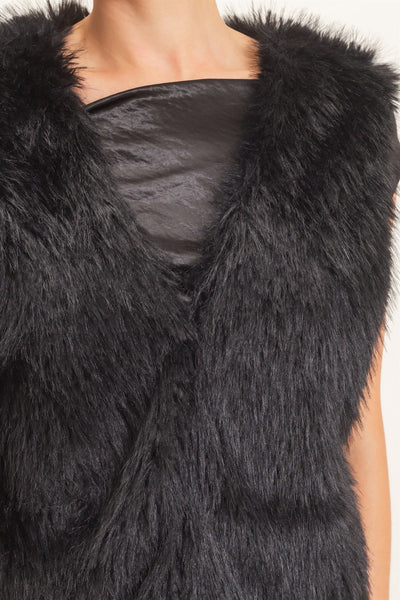 close up of black faux fur vest