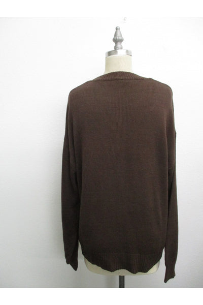 Brown sweater on a mannequin against a white background