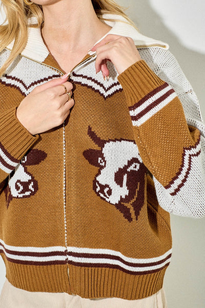 Brown sweater with cow design worn by a person