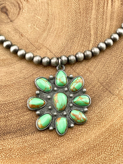 close up of cluster pendant on wooden background