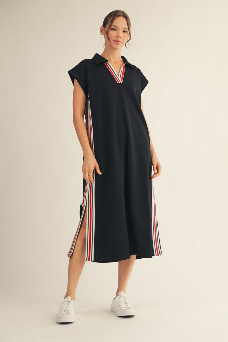 model wearing a black dress with stripes along the sides & neckline.