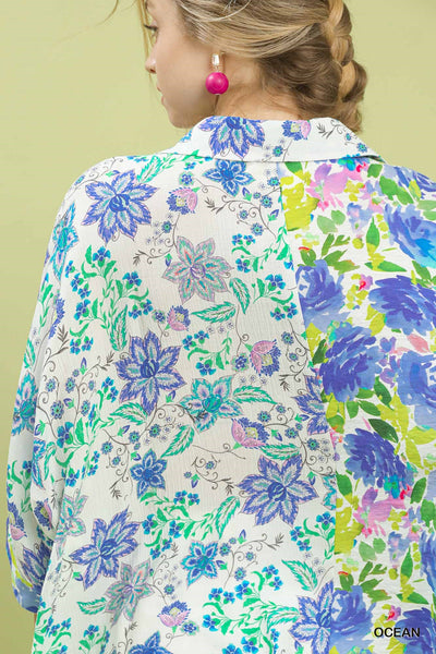 Floral patterned shirt with colorful flowers on a plain background