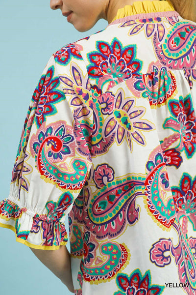 Colorful paisley patterned blouse with a blue background