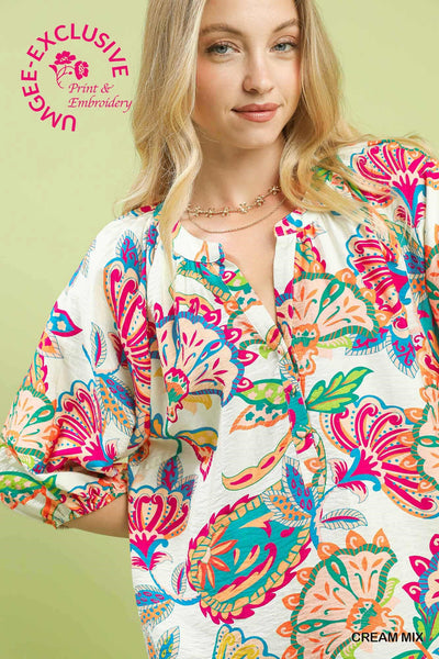 Woman wearing a colorful patterned shirt on a green background