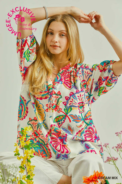 Woman wearing a colorful floral blouse with a white background