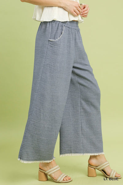 Person wearing light blue pants on a green background