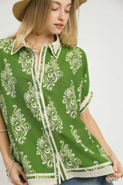 Woman wearing a green patterned shirt with a white background