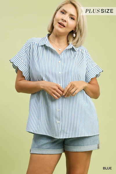 Woman wearing a blue and white striped shirt with shorts on a light green background