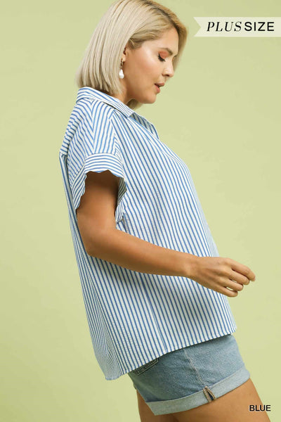 Woman wearing a blue and white striped shirt on a light green background